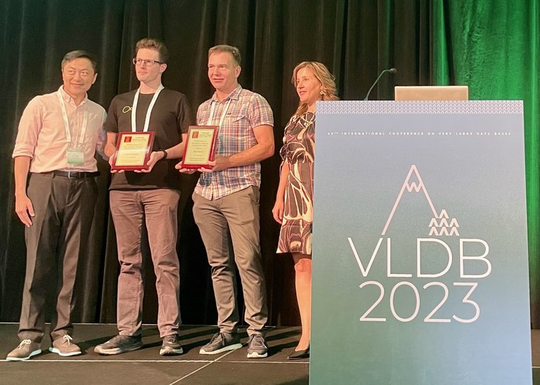 VLDB 2023 Best Paper Award ceremony, with Gábor Szárnyas and Peter Boncz from CWI.