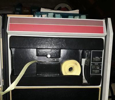 Rolled-up punched tape in the PDP-11. A roll of punched tape being read on Geert Rolf’s PDP-11/10, as part of the project to digitize and preserve CWI’s historic tape collection. Picture: Geert Rolf.