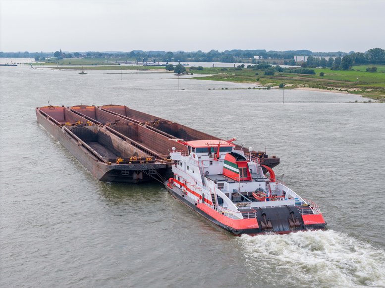 An aerial drone shot of a cargoship on the Waal, in the Netherlands.