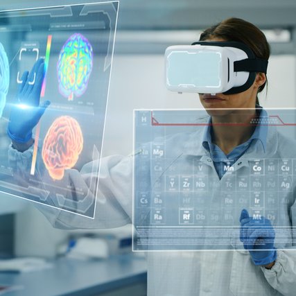 Portrait of futuristic researcher using the augmented reality vr glasses with hologram graphics for viewing results of research in laboratory.